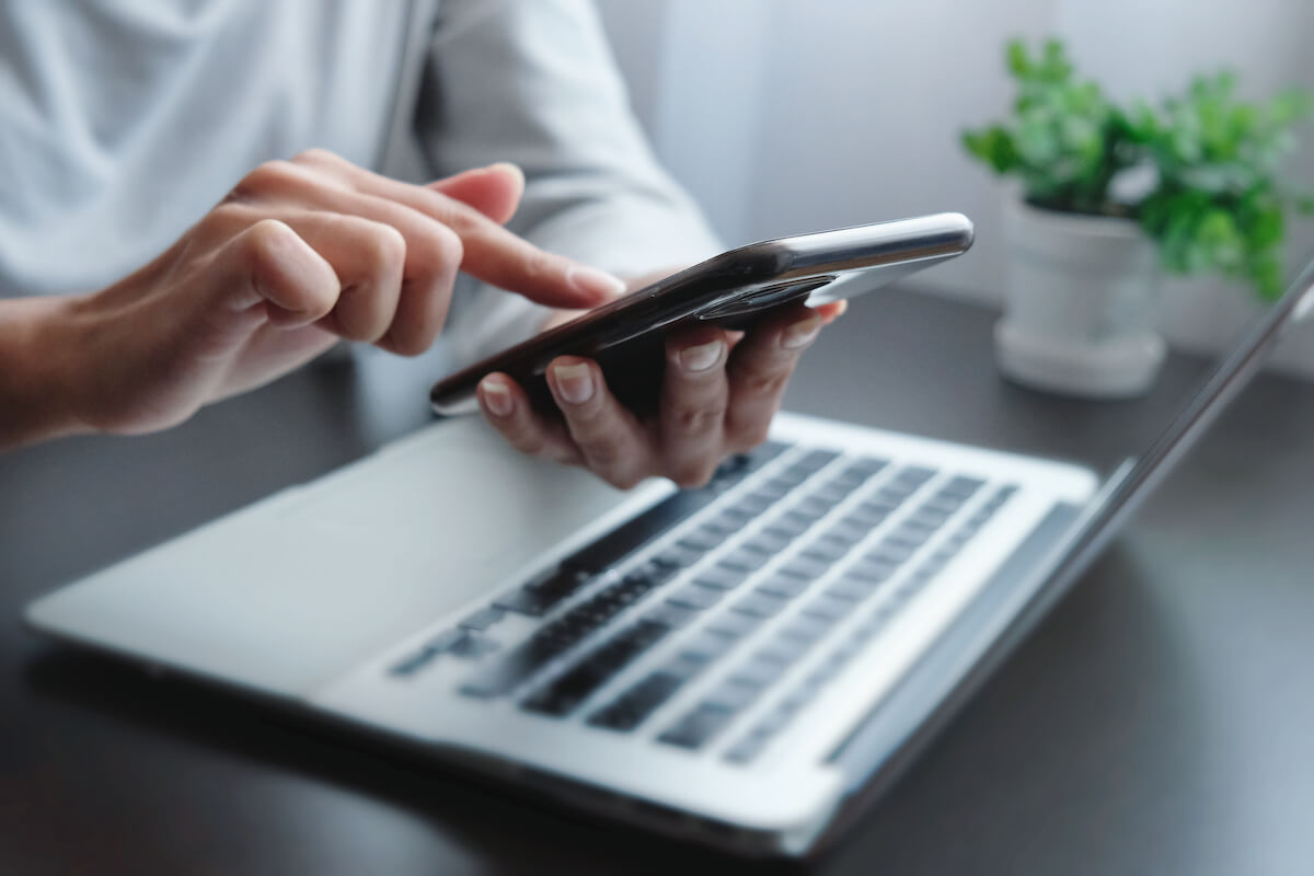 laptop and phone being used at the same time 